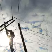 tech - silhouette of worker man on telephone pole