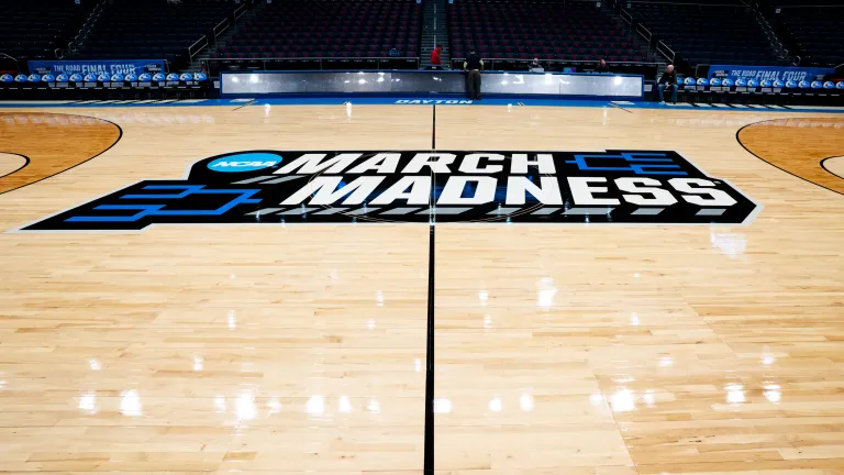 basketball court featuring the NCAA March Madness logo 