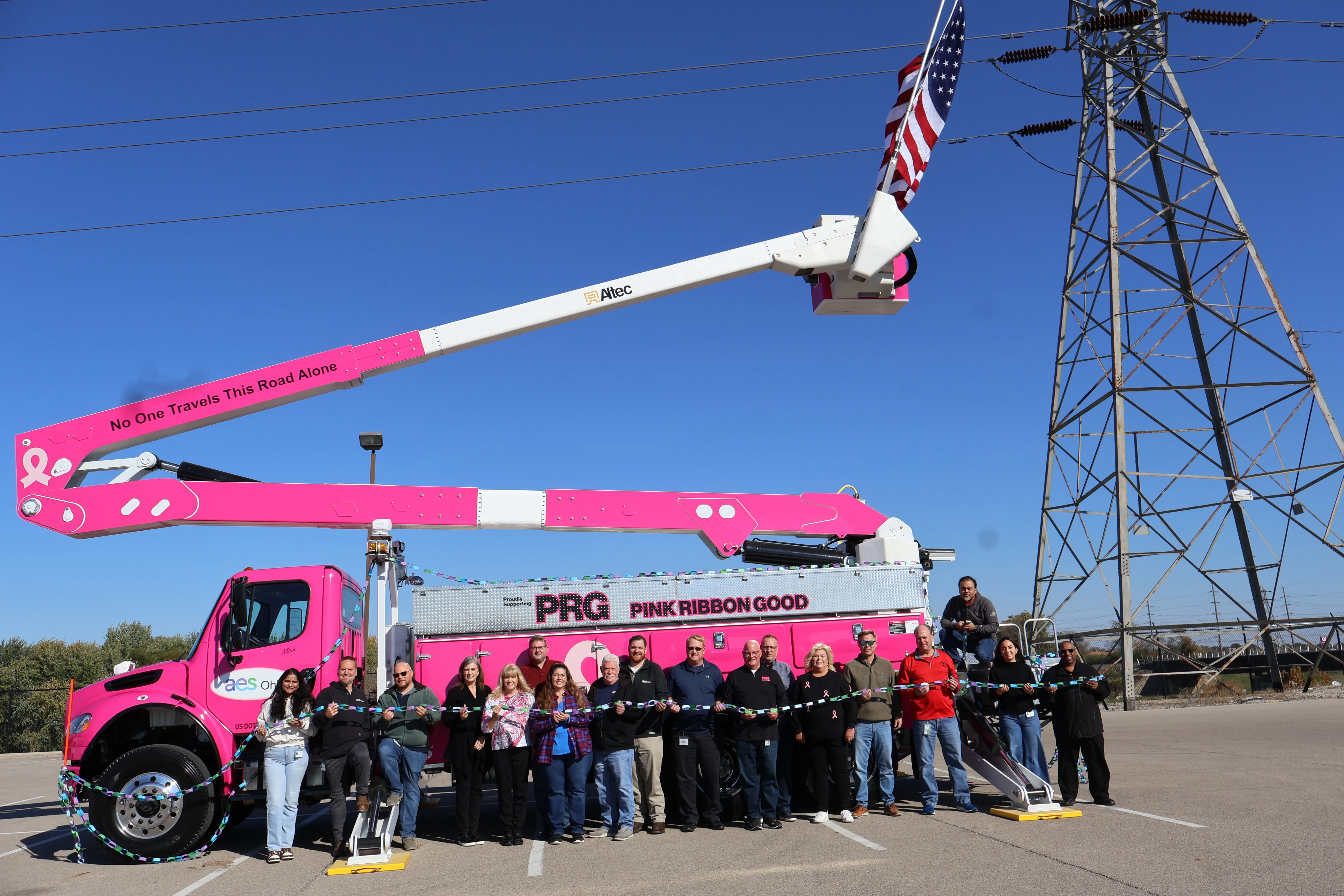 AES Ohio team supports Pink Ribbon Good during a community awareness event featuring a utility bucket truck.