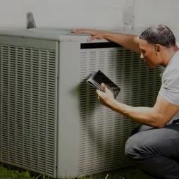 Man resting arm on air conditioner